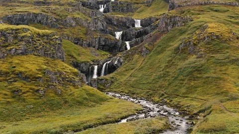 Aerial drone shot of multiple tiers of water of Klifbrekkufossar waterfall Stock Footage 116211475