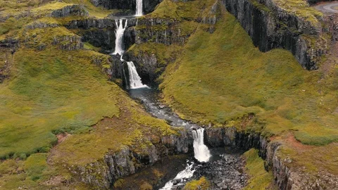 Aerial drone shot of multiple tiers of water of Klifbrekkufossar waterfall Stock Footage 116213068