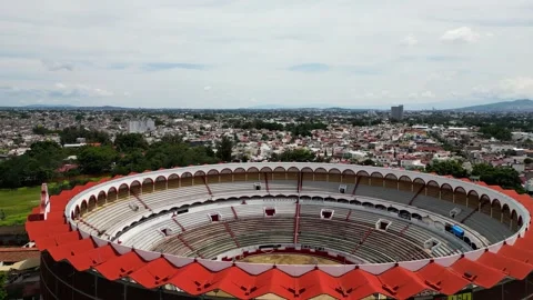 Aerial drone shot of Nuevo Progreso Bullring in Guadalajara, with cityscape Stock-Footage 334896975