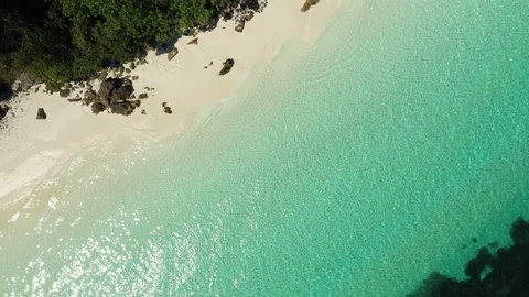 Aerial drone shot of ocean waves, beach and rocky  Stock Footage 123770984