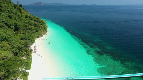Aerial drone shot of ocean waves, beach and rocky  Stock Footage 123771006