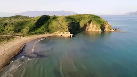 Aerial drone shot of ocean waves rolling and crashing on a sandy beach Stock-Footage 244774476