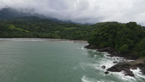 Aerial Drone Shot of Ocean Waves Crashing Against Rocky Cliffs in Costa Rica Stock Footage 336609649