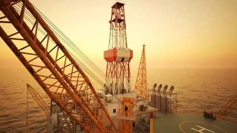 Aerial drone shot of an offshore oil platform during sunset Stock Footage