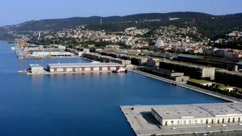Aerial drone shot of old docks in trieste with hills in background Stock Footage 233657320