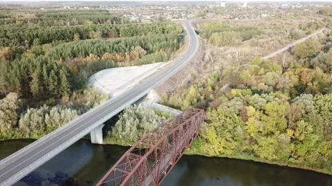 Aerial drone shot of old rusty iron disused railway bridge over the river. Video stock 150362989
