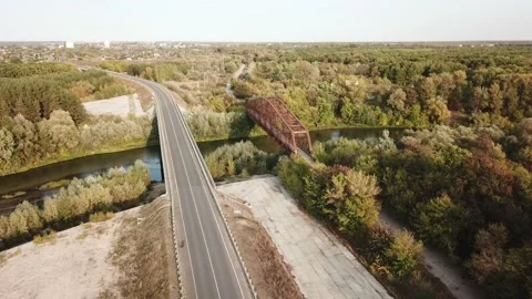 Aerial drone shot of old rusty iron disused railway bridge over the river. Video stock 150363058