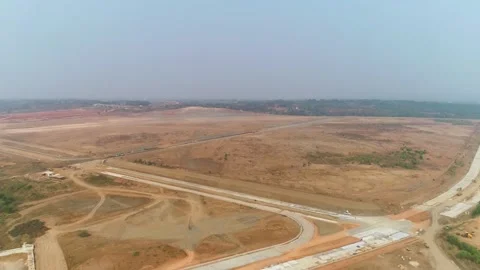 Aerial drone shot of open terrain and highway infrastructure development Video stock 346271384