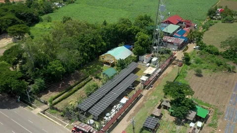 Aerial Drone Shot Orbiting Cell Tower With Solar Panels Near Agricultural Field 스톡 동영상 345062174