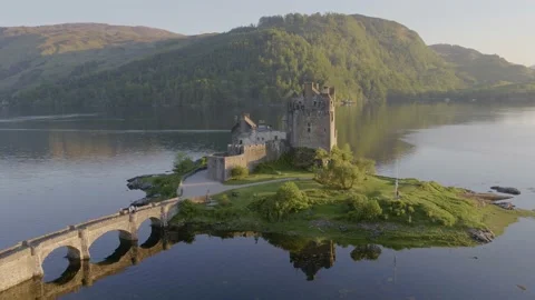 Aerial drone shot orbiting Eilean Donan Castle in Scotland Stock Footage 132877148