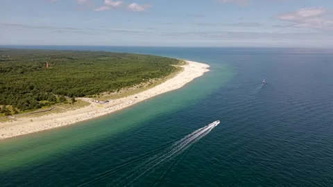 Aerial drone shot orbiting the forested tip of the Hel Peninsula in Poland, a Stock Footage 342235489