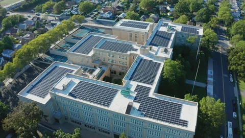 Aerial Drone Shot Orbiting a Large PV Solar Installation on Bayside High School Stock Footage 143218368