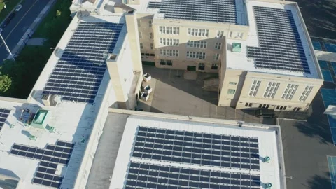 Aerial Drone Shot Orbiting a Large PV Solar Installation on Bayside High School Stock Footage 143219959