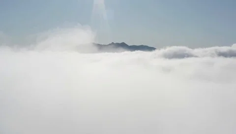 Aerial drone shot over clouds in mountains Video stock 122442433