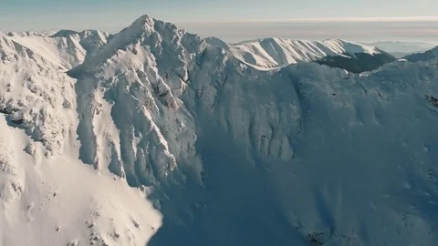 Aerial drone shot over famous Fagaras mountains covered with snow in wintertime Stock Footage