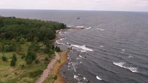 Aerial drone shot over the forest on the island. Waves at sea. Stock Footage 160143921