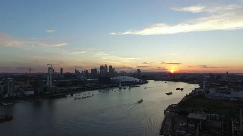 Aerial drone shot over the Thames and London skyline at sunset Stock Footage