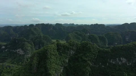 Aerial drone shot of panoramic view of tops of mountains in Ninh Binh Stock Footage 166545243