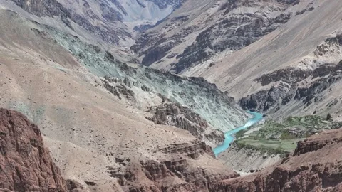 Aerial drone shot of pristine blue waters flowing past an isolated monastery Stock Footage 310752296