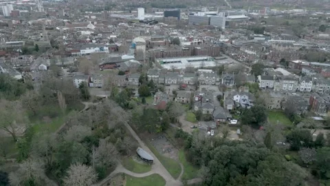 Aerial Drone shot pulling back from park to view across Ipswich town centre Stock Footage 242121473