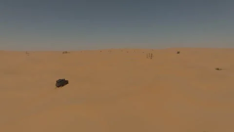 Aerial drone shot of a Range Rover Classic stuck in the Sahara Desert sand. 動画素材 335444654