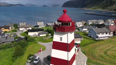 Aerial drone shot of red-white lighthouse on the edge of Norway with the ocea Stock Footage 138721295