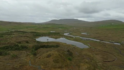 Aerial drone shot of a remote valley with a village on the Faroe Islands Stock Footage 337783922