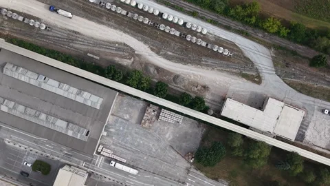 An aerial drone shot reveals an active industrial complex with roads, rail Stock Footage 342209846