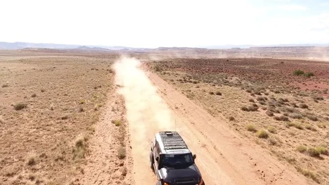Aerial drone shot of off road truck driving through desert Stock Footage