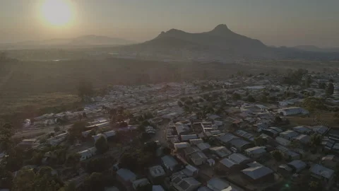 Aerial drone shot of rooftops and hills in Malawi, Africa Stock Footage 276109720