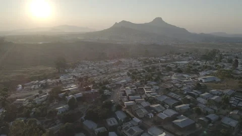 Aerial drone shot of rooftops and hills in Malawi, Africa LOG Stock Footage 276111332