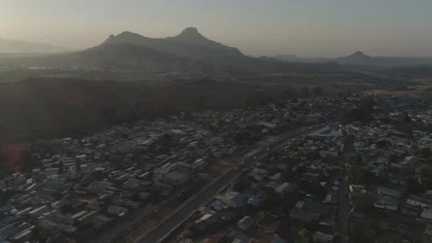 Aerial drone shot of rooftops and hills in Malawi, Africa LOG Stock Footage 276111351