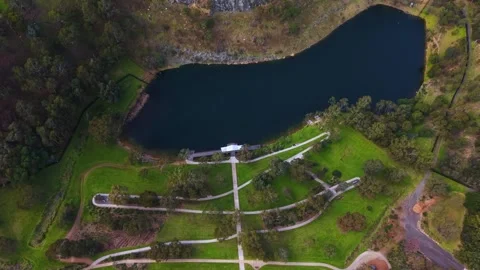 Aerial drone shot rotating over a landscaped park and lake Stock Footage 339377659