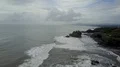 Aerial drone shot rough coastline waves at Bali Tanah Lot water temple 4k or 4k+ Resolution