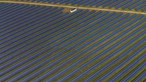 Aerial drone shot of rows of solar panels bisected with a line Stock Footage 159799366