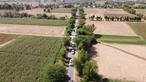 Aerial drone shot of sequence running car in Indian villages. Stock Footage 244592923