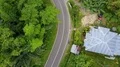 Aerial drone shot serpentine road in urban forest landscape of Flores 4k or 4k+ Resolution