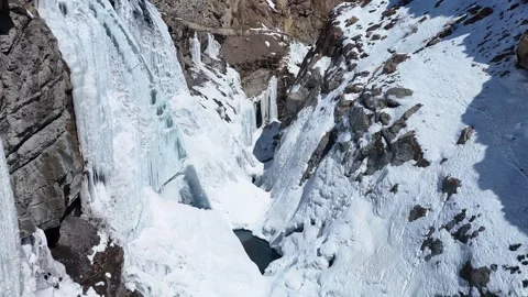 Aerial drone shot showcasing the mesmerizing beauty of Lingti Waterfall, Stock Footage 304945363
