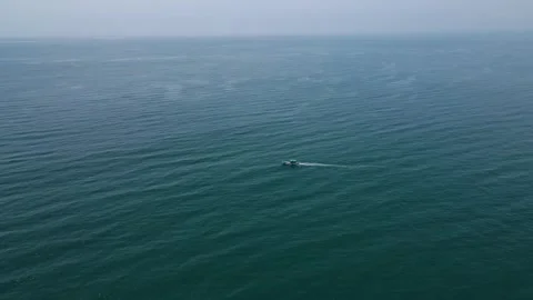 Aerial drone shot showcasing a small fisher boat drifting in the heart of the Stock Footage 297596483