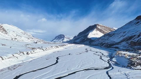 Aerial drone shot showcasing the tranquility of Kaza, where fresh snow blankets Stock Footage 304944727