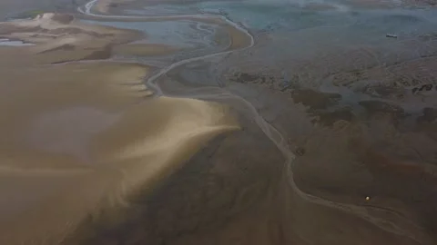 Aerial drone shot showing patterns of sand and water on the AONB Norfolk coast Stock Footage 159970739