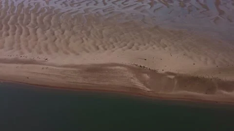 Aerial drone shot showing patterns of water with sand on the AONB Norfolk coast Stock Footage 159970885