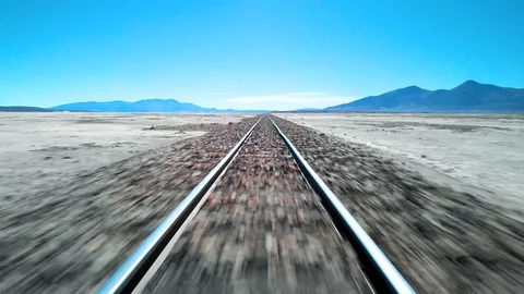Aerial drone shot speeding down train tracks in Uyuni Bolivia Stock Footage 128014324