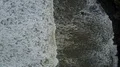Aerial drone shot straight down rough coastline waves at Bali Tanah Lot 4k or 4k+ Resolution