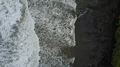 Aerial drone shot straight down coastline waves at Bali Tanah Lot water temple 4k or 4k+ Resolution