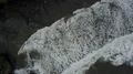 Aerial drone shot straight down coastline waves at Bali Tanah Lot water temple 4k or 4k+ Resolution
