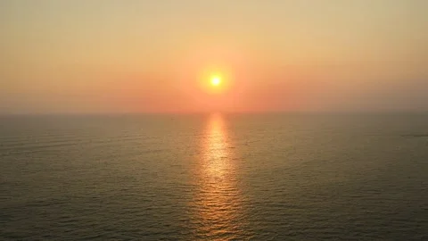 Aerial Drone Shot of the Sun Setting Over the Ocean Horizon Stock Footage 297591810