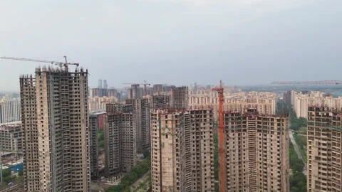 Aerial drone shot of sun setting behind the urban landscape of Noida. Stock Footage 312490737
