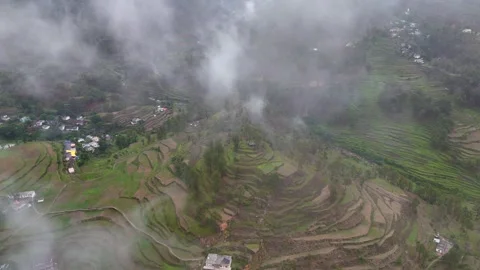 Aerial drone shot of sunrays filtering through clouds over lush mountain slopes. Stock Footage 310748048