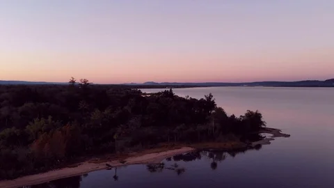Aerial drone shot from a sunrise over a lake in Paraguay Stock Footage